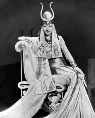 Claudette Colbert as Cleopatra on throne