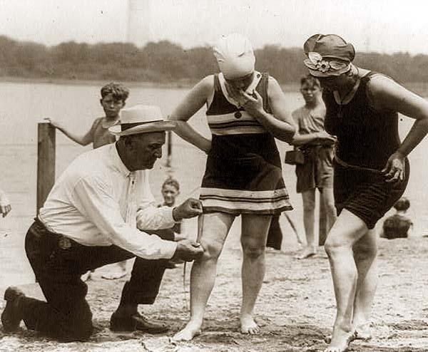 Bill-Norton-measuring-distance-of-bathing-suit-above-knee-1922.jpg